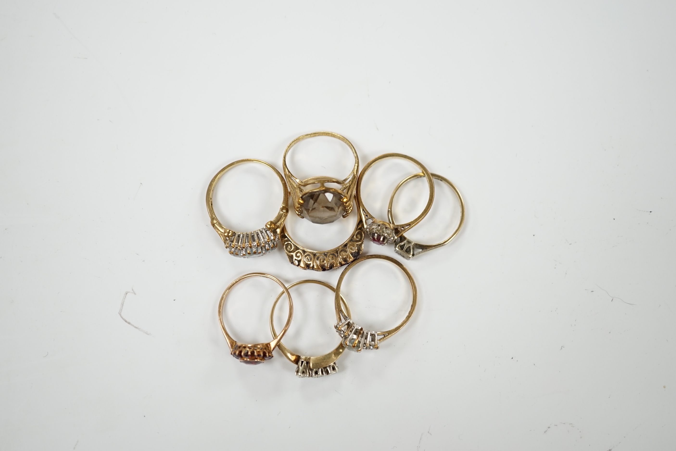 Eight assorted mainly modern 9ct gold and gem set dress rings, including diamond and garnet, 19.5 grams.